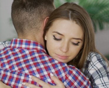comforting hug between young couple indoors