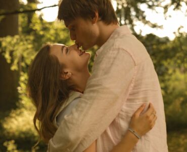 romantic couple embracing in sunlit park